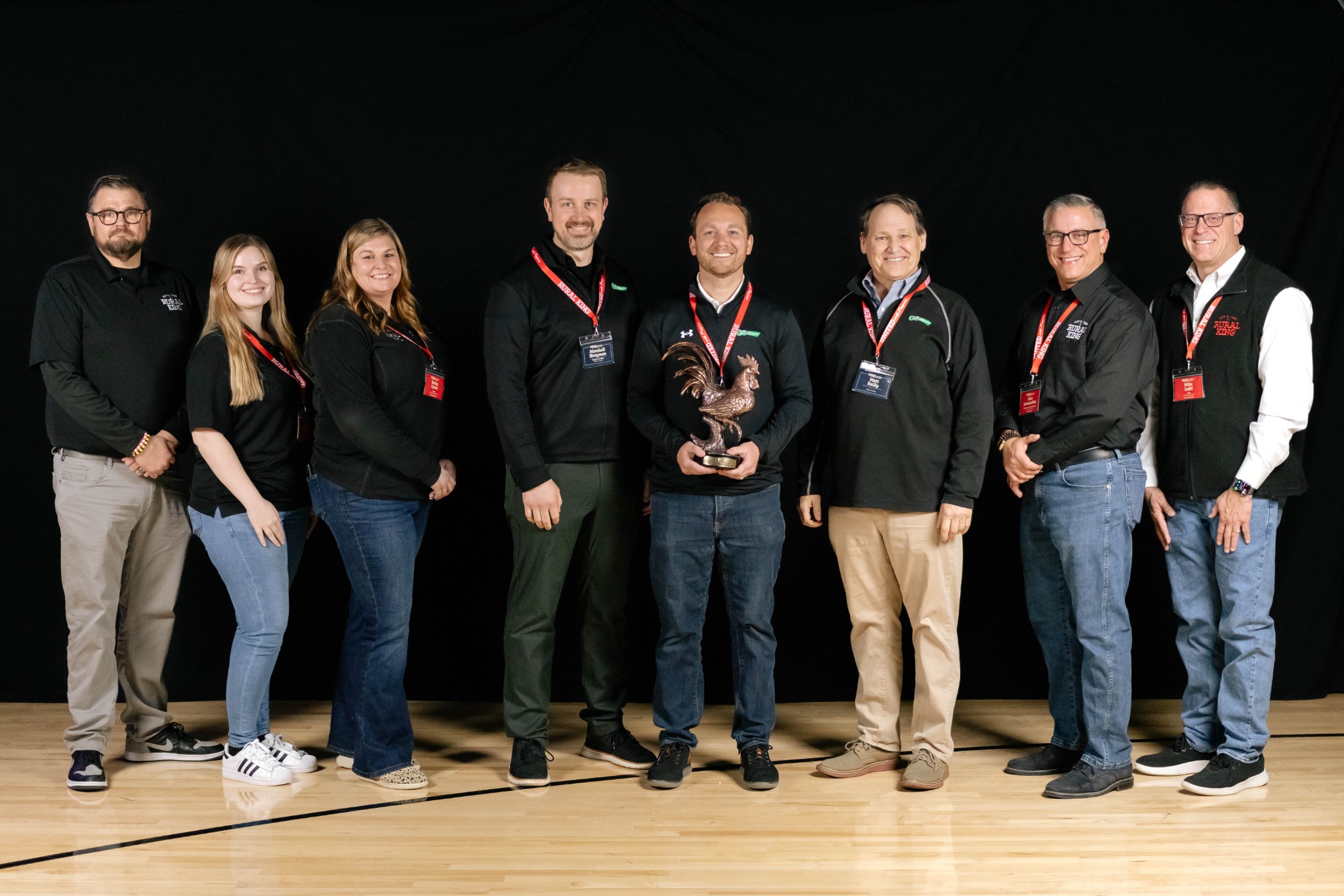 Group photograph at the Rural King award presentation, with the award visible